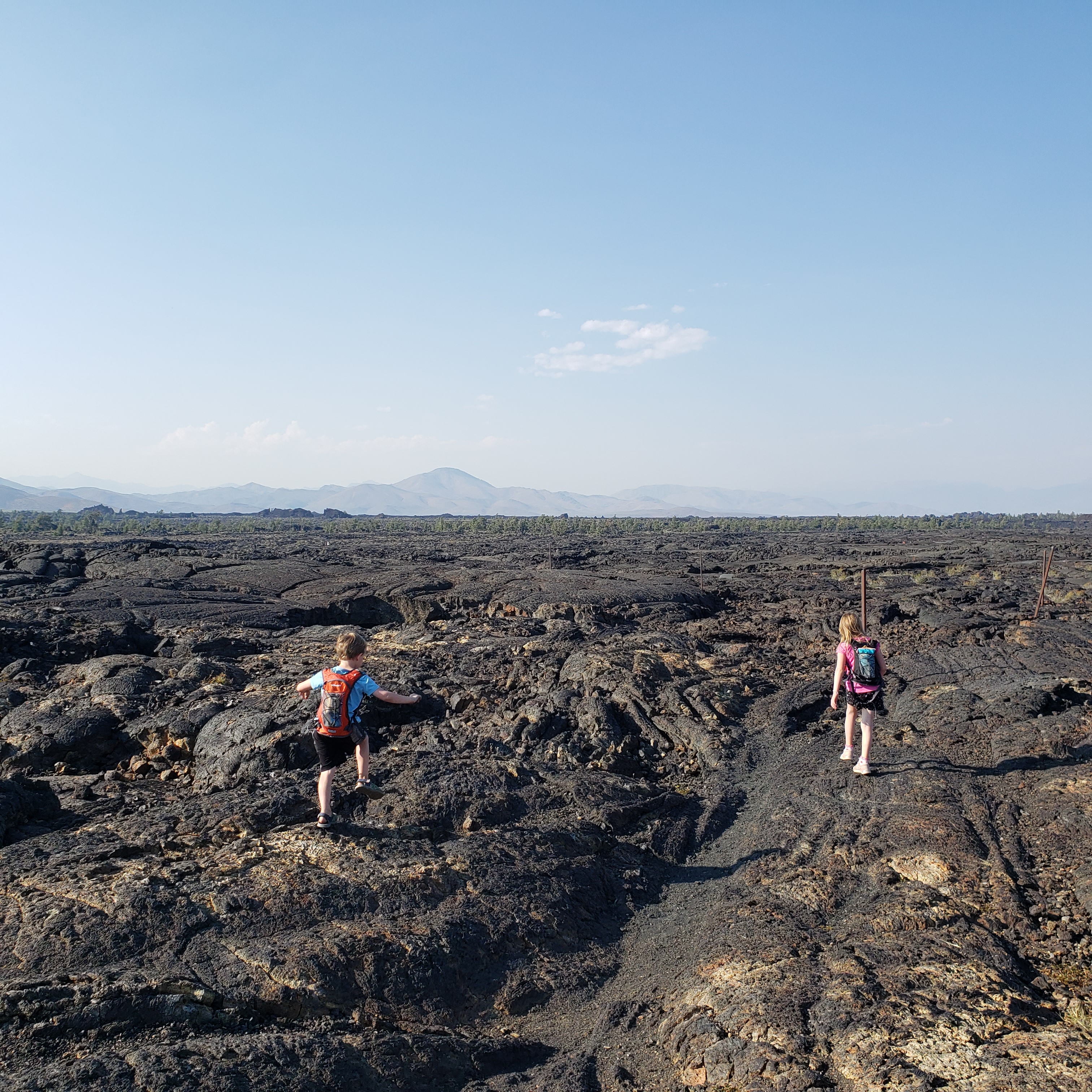 Children hiking across Craters of the Moon National Park